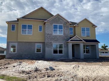 Two-story home featuring a mix of siding and stucco, complemented by large windows that brighten the facade at 977 Hawksnest Pt, Oviedo, FL 32765