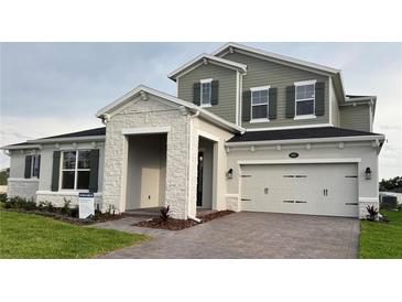 Charming two-story home featuring a stone facade, two-car garage and well maintained landscaping at 987 Hawksnest Pt, Oviedo, FL 32765