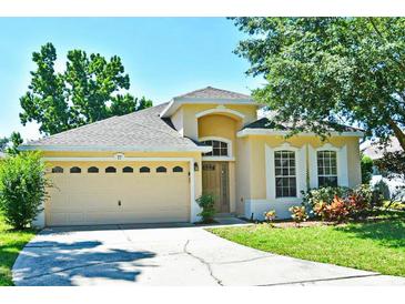 Charming single-Gathering home featuring a spacious two-car garage and a well-maintained lawn at 77 Spring Glen Dr, Debary, FL 32713