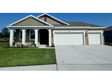 Charming single-story home with a two-car garage and well-maintained landscaping on a sunny day at 3243 Arch Ave, Ormond Beach, FL 32174