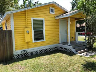 Charming yellow home with a small front porch, offering a welcoming entrance and curb appeal at 766 Carlson Dr, Orlando, FL 32804
