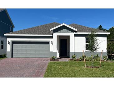 Charming single-story home featuring a two-car garage, landscaped front yard, and neutral color palette at 2063 Town Pasture Dr, Eustis, FL 32726