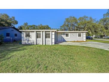 Ranch style home with gray exterior, landscaping, and driveway at 1236 Merritt St, Altamonte Springs, FL 32701