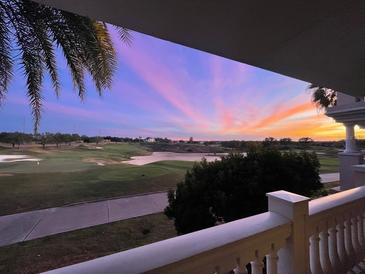 Stunning sunset over a golf course, viewed from a private balcony at 1364 Centre Court Ridge Dr # 201, Reunion, FL 34747