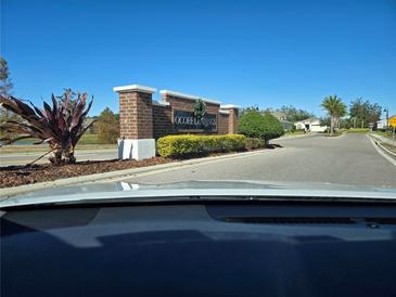 Community entrance sign featuring brick columns and landscaping at 1823 Ibis Bay Ct, Ocoee, FL 34761