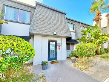 Charming townhome features a private entrance with lush landscaping and a well-maintained exterior at 1918 Conway Rd # 3, Orlando, FL 32812