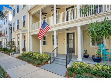 Inviting exterior of a charming townhome with a front porch and well-manicured landscaping at 4712 Anson Ln, Orlando, FL 32814