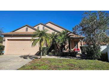 Two-story house with a two-car garage and manicured lawn at 9564 Venezia Plantation Dr, Orlando, FL 32829