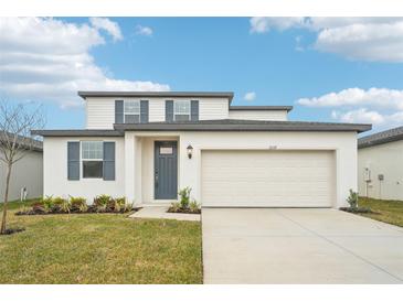 Two-story house with gray door and white siding at 2137 Rosewood Dr, Bartow, FL 33830