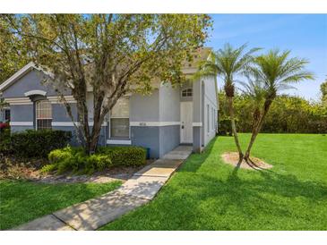 Charming home featuring a well-maintained lawn, walkway, and beautiful landscaping at 14216 Boca Key Dr, Orlando, FL 32824