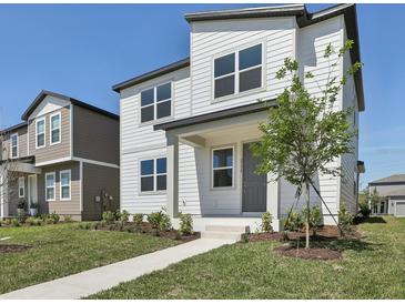 Charming two-story home with white siding, a manicured lawn, and a welcoming front porch at 2378 Broadbrook Dr, St Cloud, FL 34771