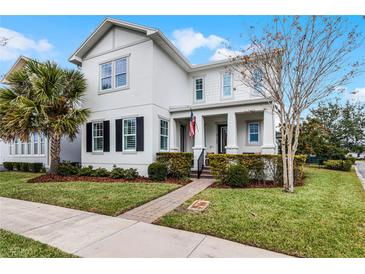 Charming two-story home with a well-manicured lawn, and covered front porch at 9133 Smithies St, Orlando, FL 32827