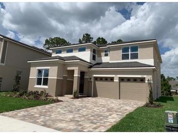Two-story home with a two-car garage and a beautiful brick driveway and front lawn at 9271 Patrimonio Loop, Windermere, FL 34786