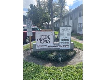 Lucerne Oaks Condominiums community sign with address and locator surrounded by lush landscaping at 134 W America St # 29, Orlando, FL 32801