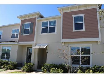 Two-story townhome with neutral siding and landscaping at 2334 Zaballina Pl, Kissimmee, FL 34747