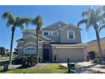 Charming two-story home featuring a well-manicured lawn and mature palm trees at 2510 Black Lake Blvd, Winter Garden, FL 34787