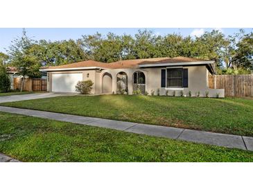 House exterior showcasing a well-maintained lawn and attached garage at 1422 Tierra Cir, Winter Park, FL 32792