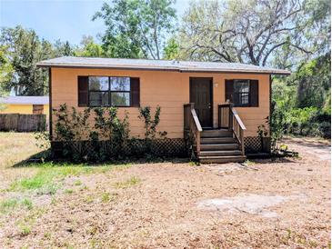 Charming single-story home with a quaint front porch and well-maintained yard at 19942 Se 155Th Pl, Umatilla, FL 32784