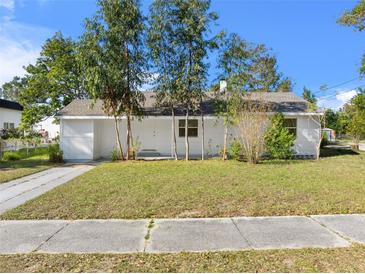 Charming single-story home with a well-maintained lawn and mature trees providing shade at 514 S 7Th St, Lake Wales, FL 33853