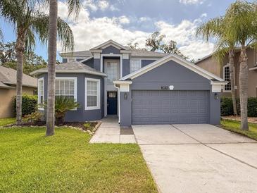 Charming two-story home features a two-car garage, lush landscaping, and a freshly painted exterior at 2806 Balforn Tower Way, Winter Garden, FL 34787