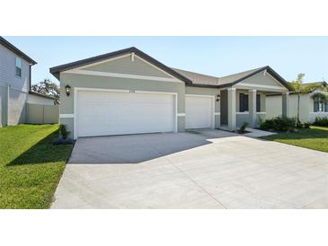 Charming single-Gathering home with a well-manicured lawn, two-car garage and a modern design at 2316 Citrus Bloom Dr, Bartow, FL 33830