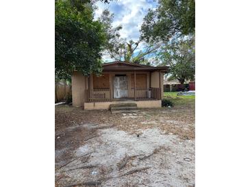 Fixer-upper house with boarded windows and a covered porch at 3108 Lawrence St, Orlando, FL 32805
