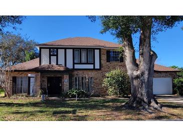 Charming two-story brick home featuring a well-manicured lawn and a classic architectural style at 9130 Dollanger Ct, Orlando, FL 32819