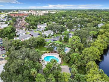 This is an aerial view of the community pool and clubhouse surrounded by lush landscaping at 105 Northlake Dr # 105, Sanford, FL 32773