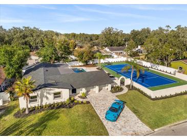 Beautiful single-story home with a pool, a private tennis court, and a long paver driveway at 2337 Worthington Rd, Maitland, FL 32751