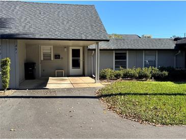 Inviting exterior of condo with carport and well-manicured lawn at 891 Jonathan Way, Altamonte Springs, FL 32701