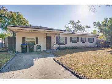 Brick ranch home with a spacious yard and driveway at 4213 Seybold Ave, Orlando, FL 32808