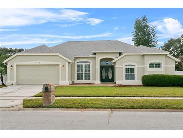 Single-story home with attached garage and landscaped lawn at 1616 Thornhill Cir, Oviedo, FL 32765