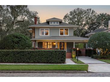 Charming two-story home with brick details and well-manicured landscaping at 450 Cherokee Dr, Orlando, FL 32801