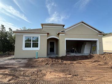 Newly constructed single-story home with a two-car garage and neutral-colored stucco exterior at 5268 Prairie Preserve Run, St Cloud, FL 34772