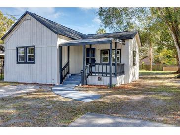Charming white house with gray accents and a covered porch at 805 Willow Ave, Sanford, FL 32771