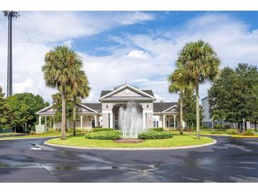 Attractive community entrance with fountain and landscaping at 3175 Feltrim Pl # 305, Kissimmee, FL 34747