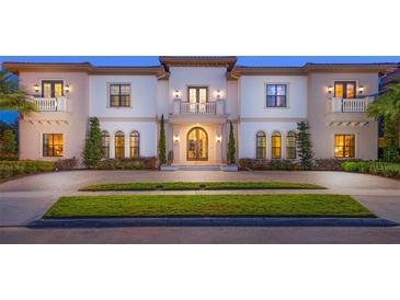 Elegant two-story home with a grand entrance and manicured lawn at 1261 Radiant St, Reunion, FL 34747