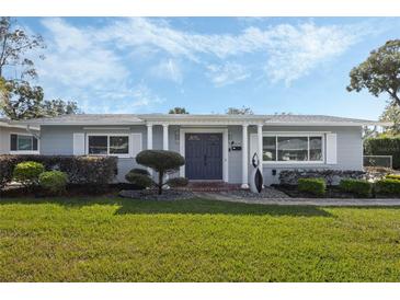 Gray house with blue door, landscaped yard, and walkway at 604 Endsley Ave, Altamonte Springs, FL 32701