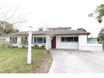 Charming single-story home featuring a well-manicured lawn and classic architectural details at 712 Grandview Ave, Altamonte Springs, FL 32701