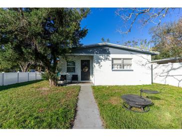 Updated bungalow with a fenced yard and firepit at 1202 Dewey Ave, Orlando, FL 32808