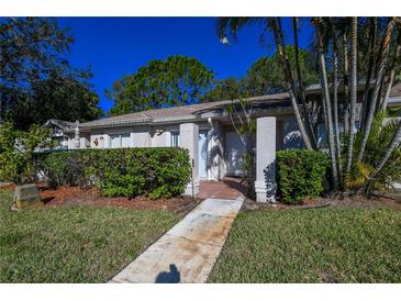 Neat condo with a well-manicured lawn and walkway at 1207 Lucaya Cir, Orlando, FL 32824