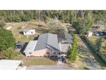 Aerial view of a single-story house with a pool and large backyard at 30844 Buttercup Ln, Mount Dora, FL 32757