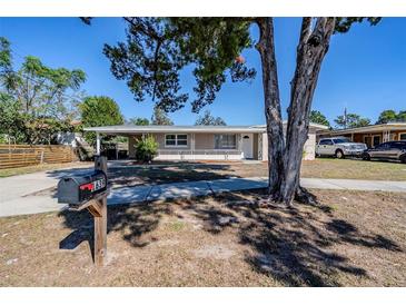 Updated single story home with a covered porch and well-manicured lawn at 1639 Hialeah St, Orlando, FL 32808