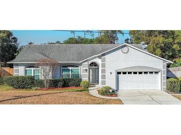 One-story house with gray siding, attached garage, and manicured landscaping at 1161 Roxboro Rd, Longwood, FL 32750