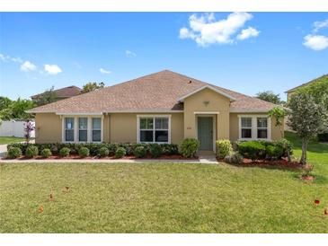 Charming single-story home with well-manicured lawn, beautiful landscaping, and a welcoming front entrance at 218 Black Springs Ln, Winter Garden, FL 34787
