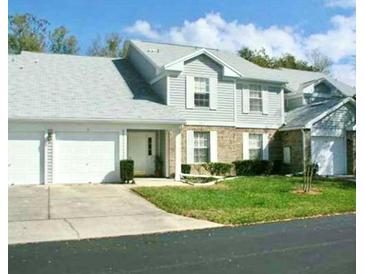 Inviting two-story townhome with a two-car garage and well-manicured lawn at 5271 Whitstable Way # 1, Orlando, FL 32812