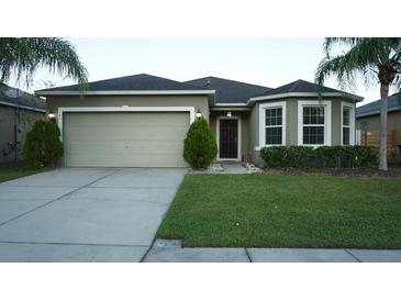 Attractive single-story house with a two-car garage and well-manicured lawn at 180 Daigledog St, Saint Cloud, FL 34772