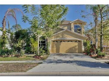 Two-story house with a two-car garage and landscaped front yard at 2981 Viscount Cir, Kissimmee, FL 34747