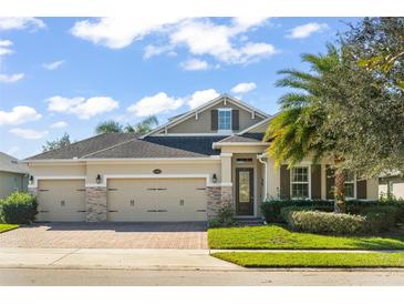 Two-story house with three-car garage and landscaping at 31921 Redtail Reserve Blvd, Sorrento, FL 32776