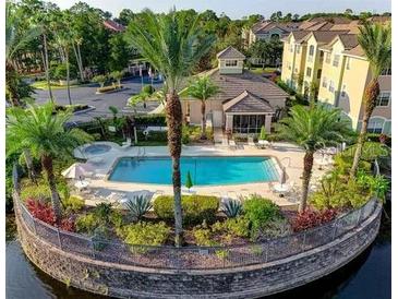 Resort-style pool with clubhouse, lush landscaping, and serene lake views at 4849 Cypress Woods Dr # 1310, Orlando, FL 32811